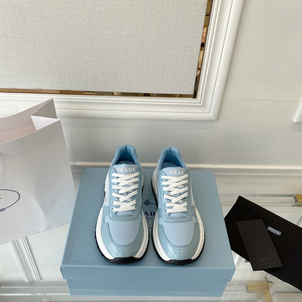 PRADA 25S THICK SOLE SNEAKER IN LIGHT BLUE CALFSKIN AND CANVAS