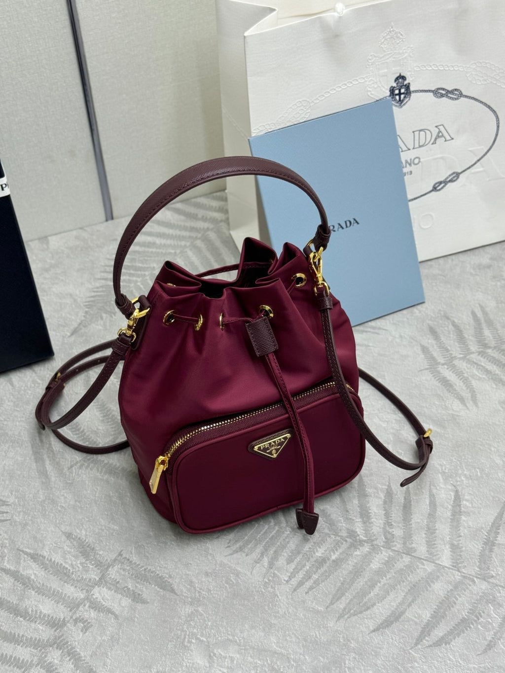 PRADA 25S DUET BUCKET BAG 23 IN BURGUNDY RE-NYLON GOLD HARDWARE